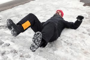 A man on his back following an ice accident. 