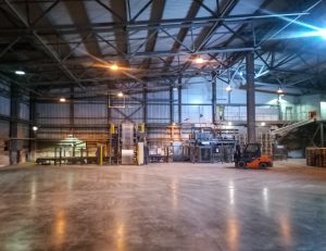 Potential hazards in a warehouse hidden by poor lighting. 
